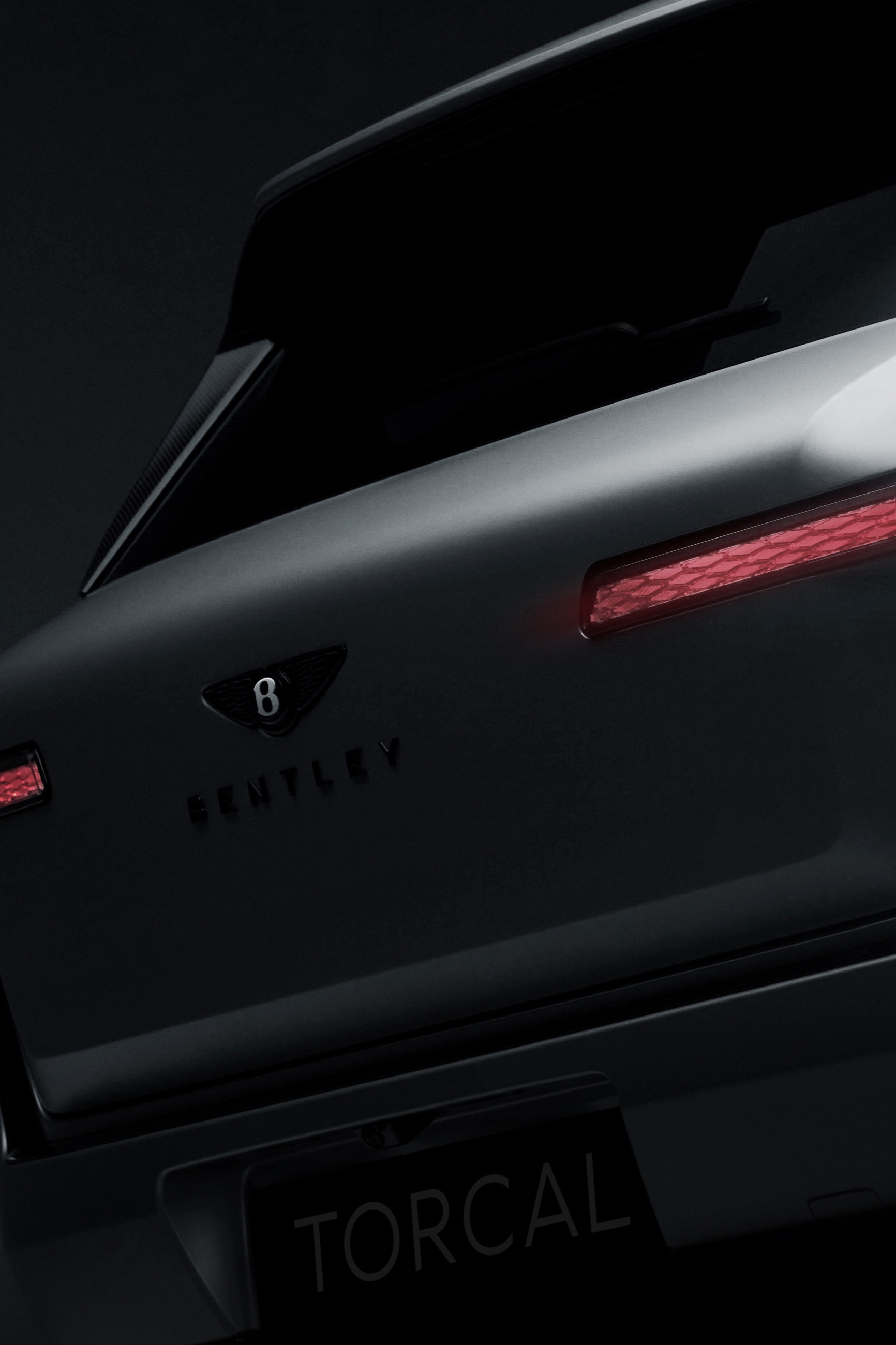 The rear of the new Bentley Torcal, badged and revealed in shadow